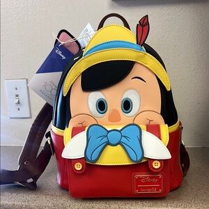 Loungefly Disney 100 Decades Pinocchio Red and Yellow Mini Backpack